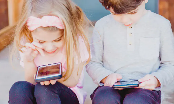 A girl and a boy using Android smartphone