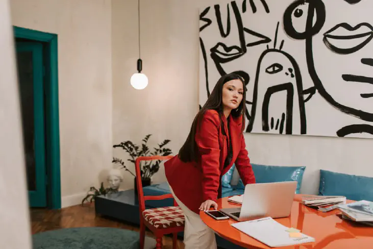 Woman standing next to the table